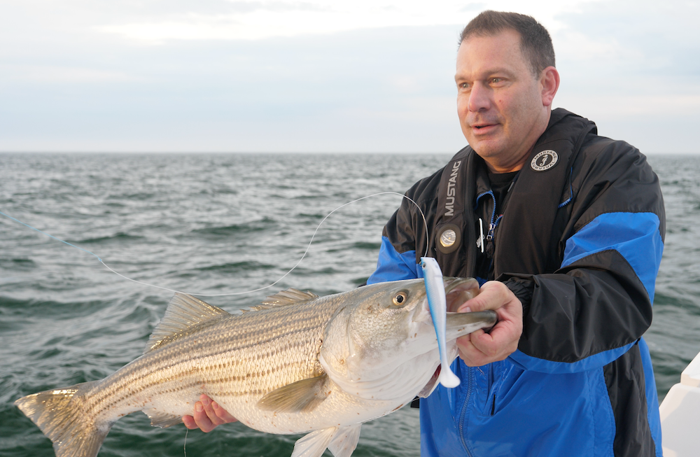 Darren Jacobs member with striped bass group trip
